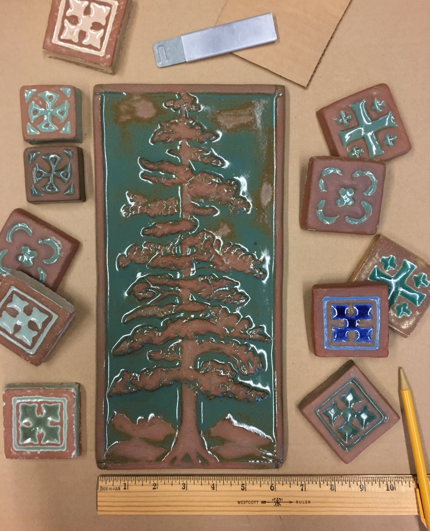 A Redwood Buffed tree tile surrounded by smaller Handcraft decorative tiles